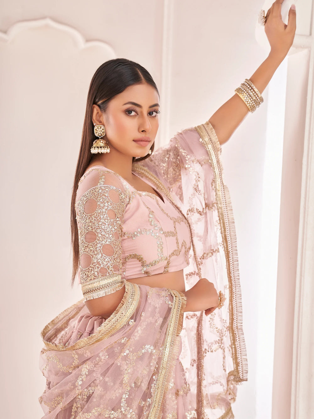 Prominent Pastel Pink Sequins Embroidery Net Lehenga Choli for Women