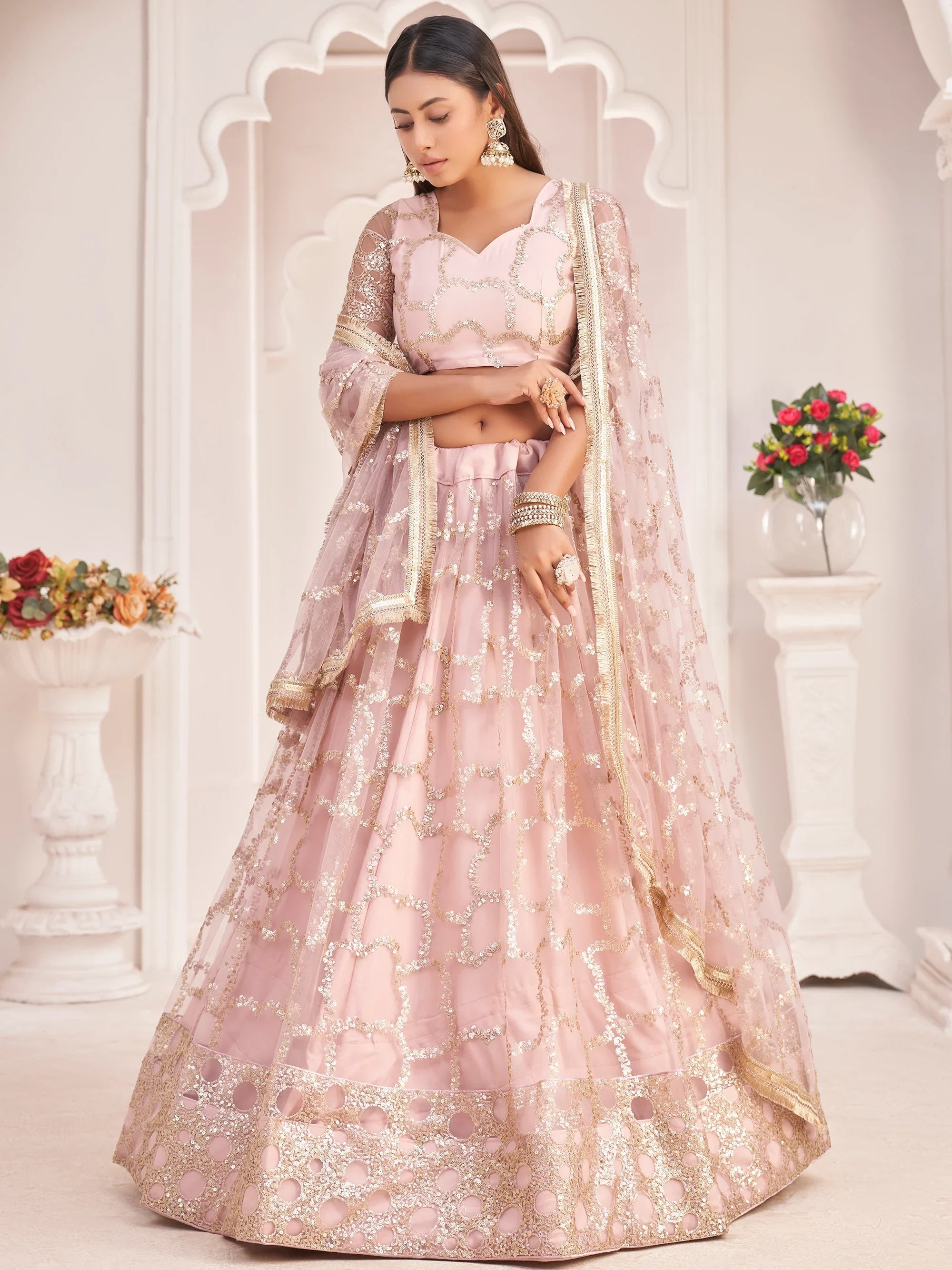 Prominent Pastel Pink Sequins Embroidery Net Lehenga Choli for Women