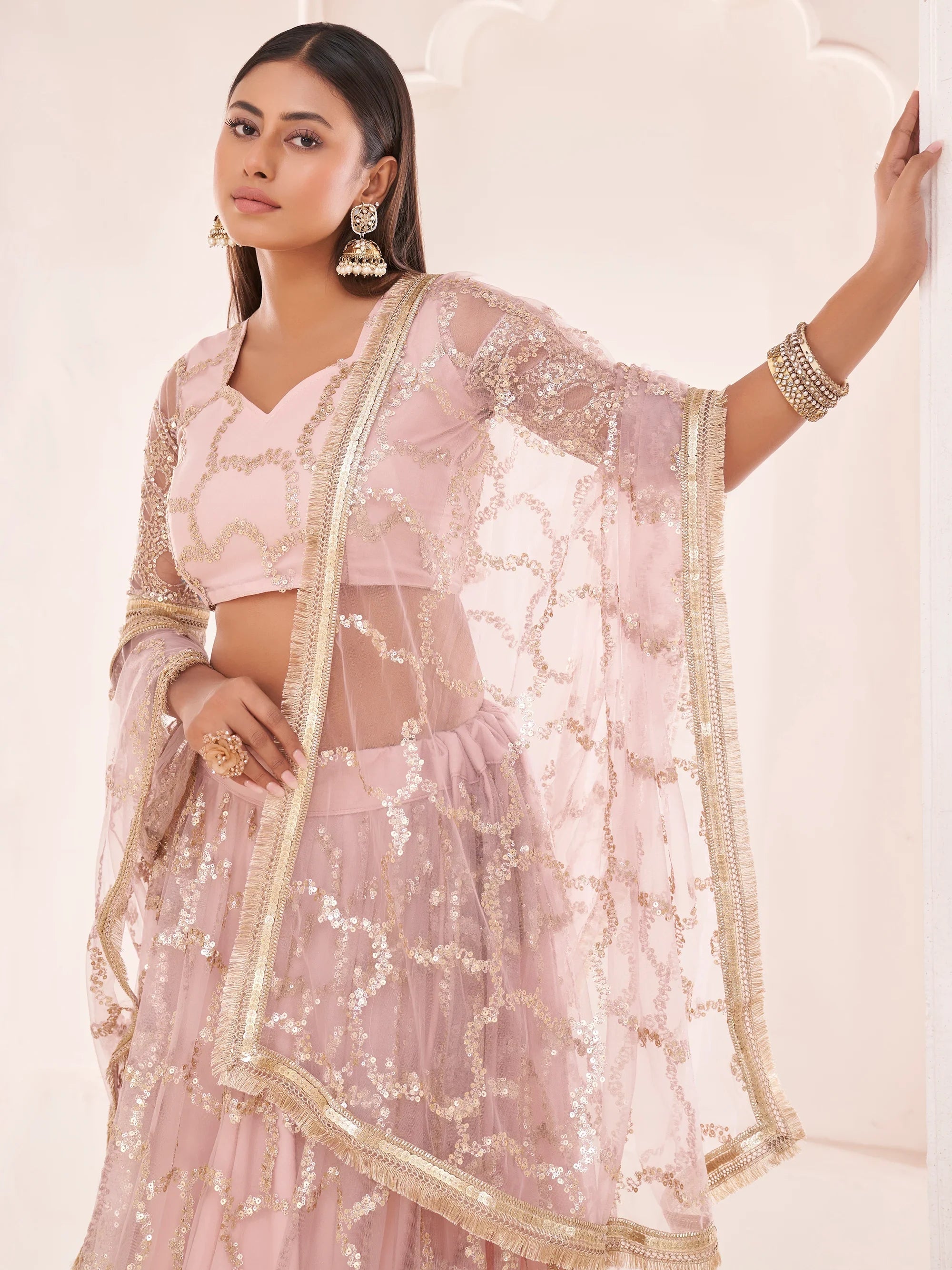Prominent Pastel Pink Sequins Embroidery Net Lehenga Choli for Women