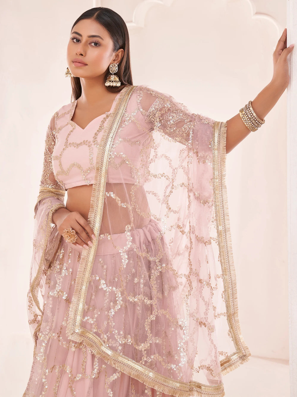 Prominent Pastel Pink Sequins Embroidery Net Lehenga Choli for Women